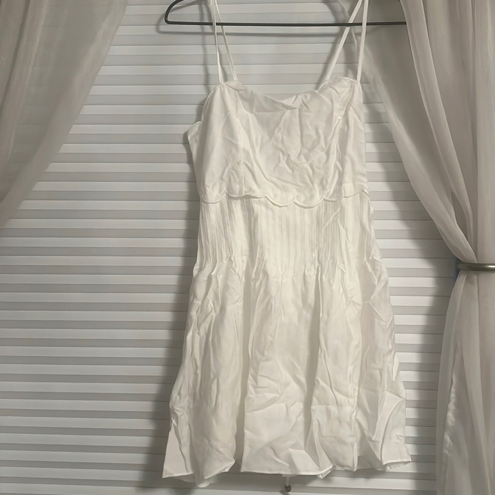 it is a white mini dress. size large. brand new, with tags.